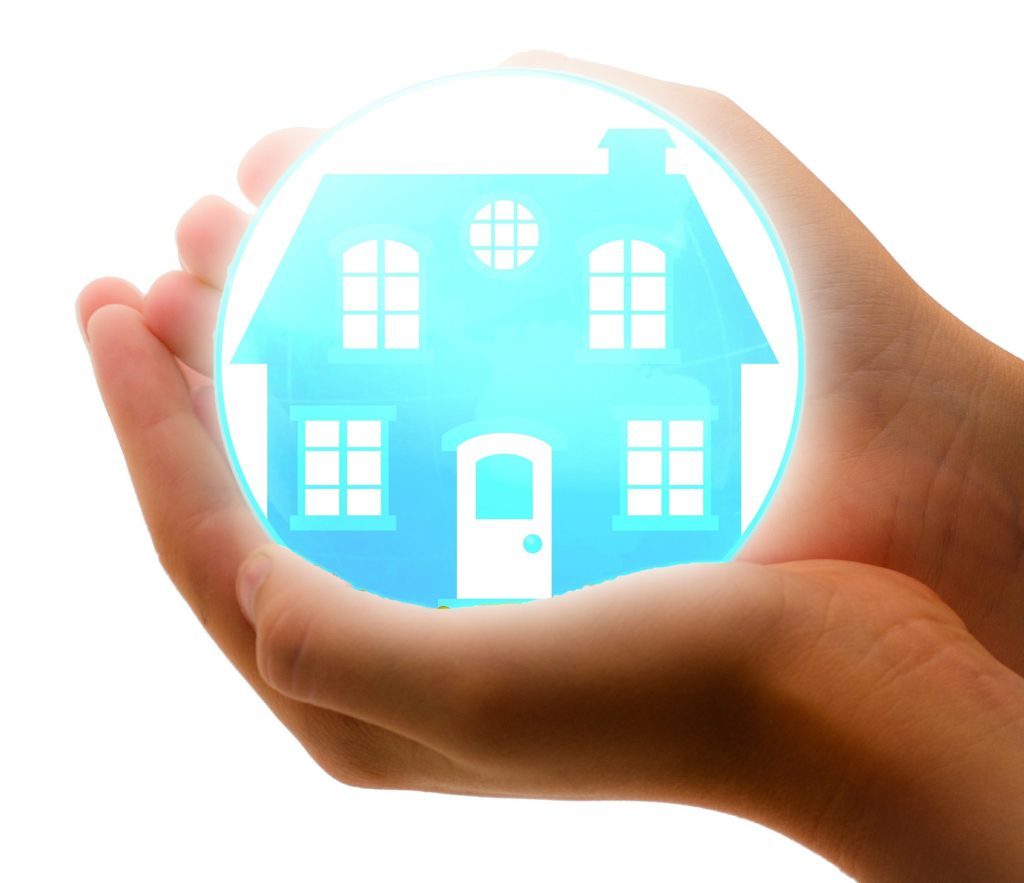 home with a hand holding it representing energy efficient rentals