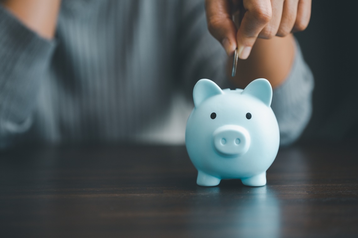 landlord inserting coin in piggy bank signifying using a self directed ira for real estate